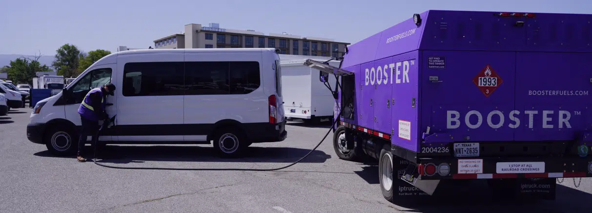 Purple Tanker filling white passenger van