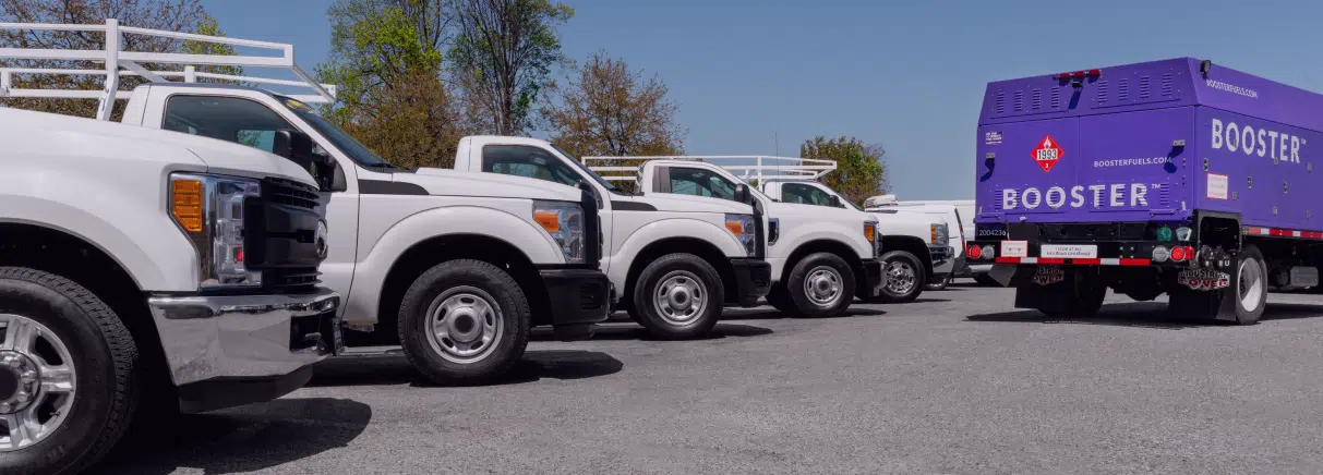 tanker fueling row of white vehicles